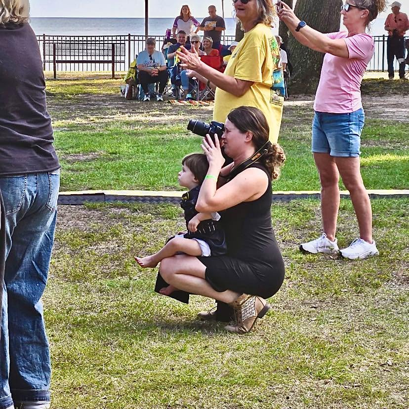Satyn photographing an event with Malachi beside her